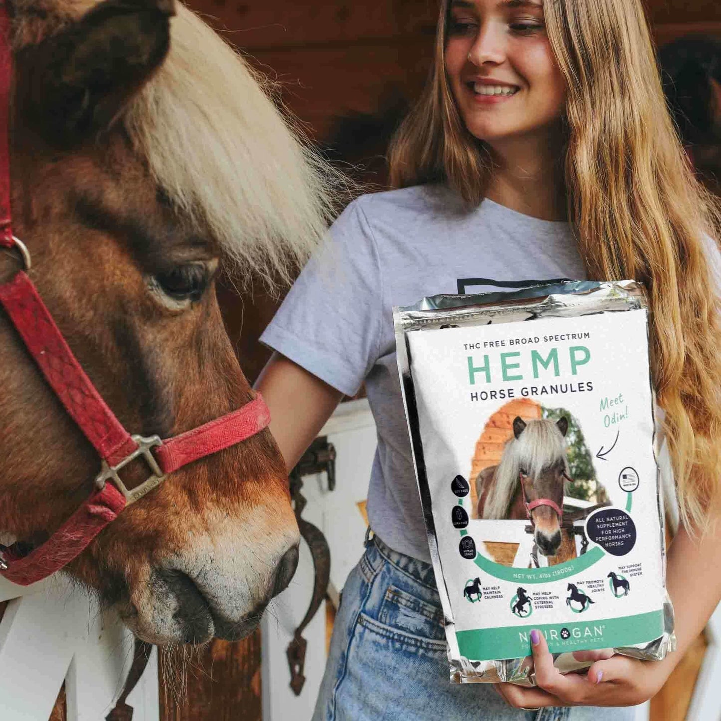 Hemp Horse Pellets bag held by a woman feeding pellets to a horse.